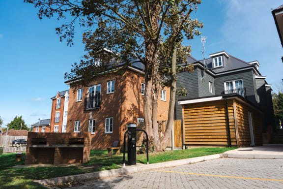 a large brick house with a tree in front of it