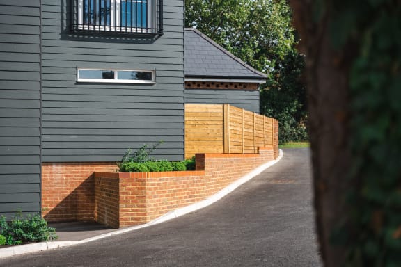 a brick retaining wall in front of a house