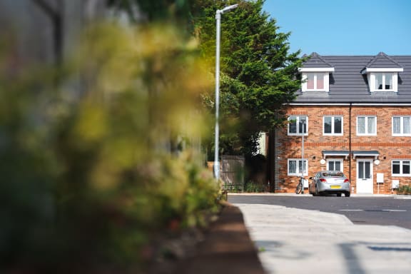 a car parked on a street in front of a house