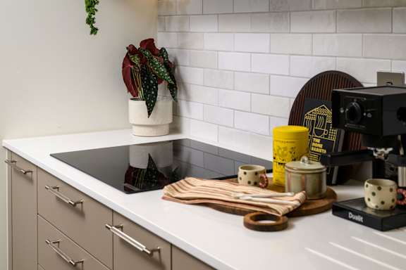 A kitchen counter with a camera and some objects on it.