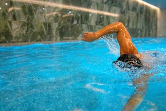 A man swimming in a pool.