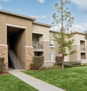 exterior of apartment building at camino real with green grass