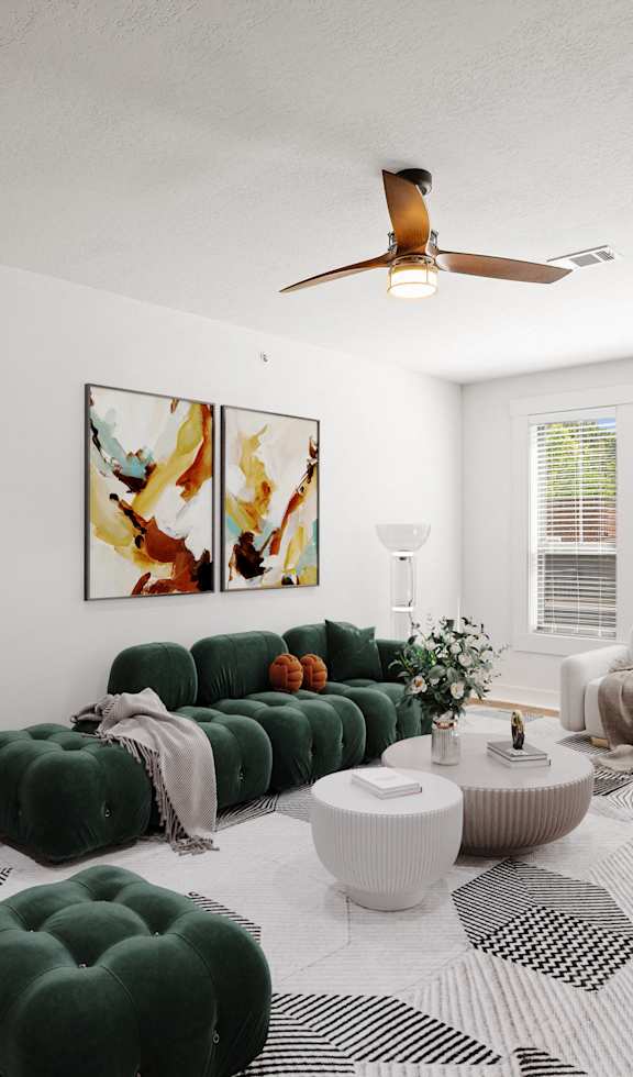 A living room with hardwood floors, a ceiling fan, and three windows providing natural lighting.