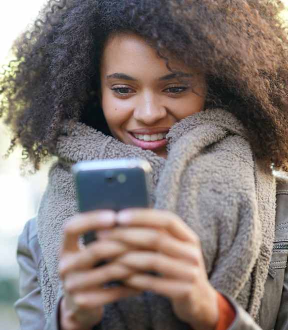 Woman using her phone at Amara Luxury Apartments, California, 95834