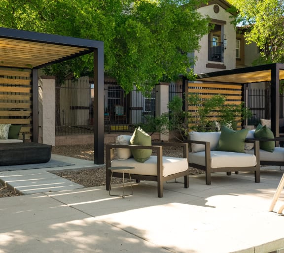 a patio with furniture and a wooden fence