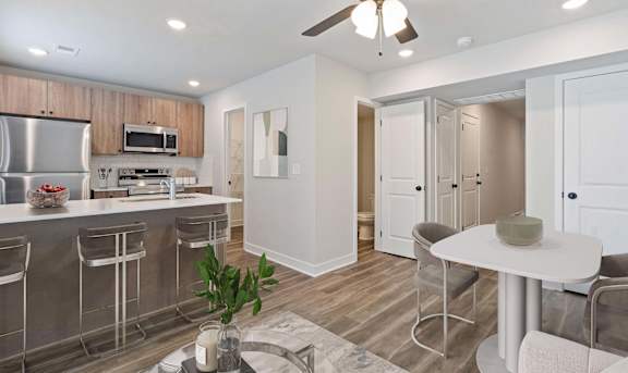A modern kitchen with a bar area and a dining table.