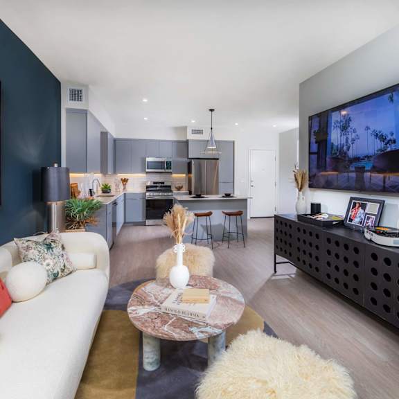 A modern living room with a white sofa and a coffee table.