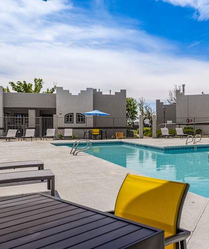 our apartments have a resort style pool with chairs and tables