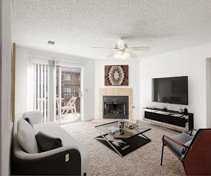 a living room with a couch and a chair and a fireplace