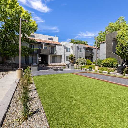 Yard of a House With a Lawn at Odyssey Apartments, New Mexico