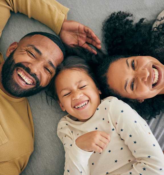 Family is lying down together at The Groves Apartments, Raleigh, 27604