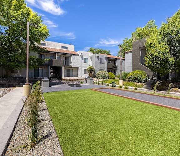 the yard of a house with a lawn and a sidewalk