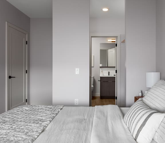 A bedroom with a large bed and a painting on the wall.