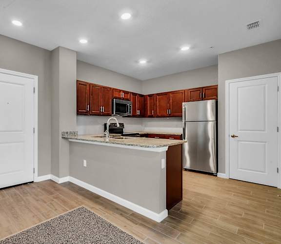 a kitchen with an island and stainless steel appliances