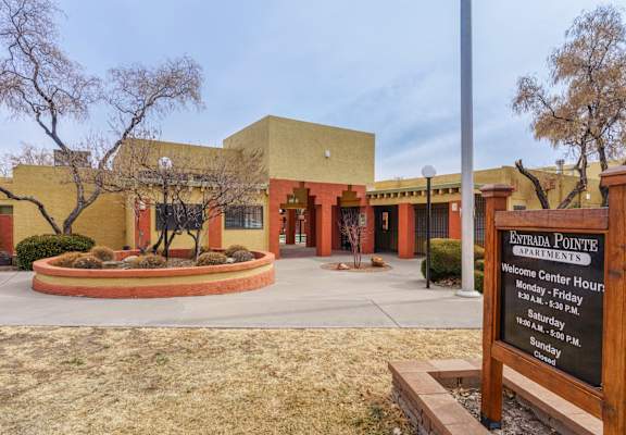 A sign in front of a building that says Estrada Pointe Apartments.