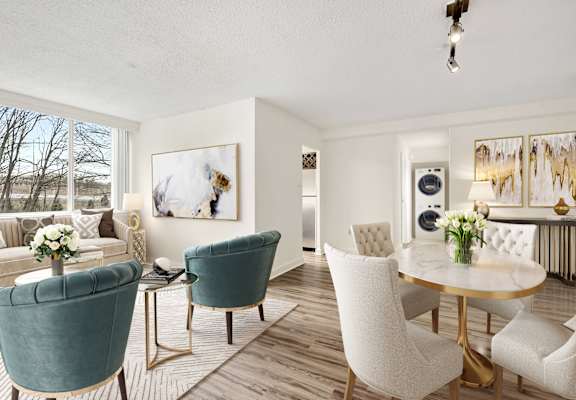 a living room and dining room with white chairs and a table