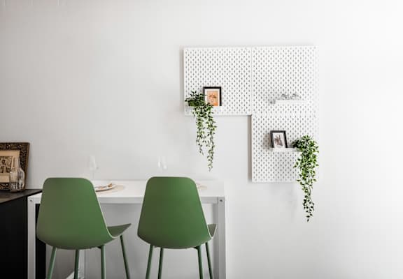 a room with green chairs and a white table