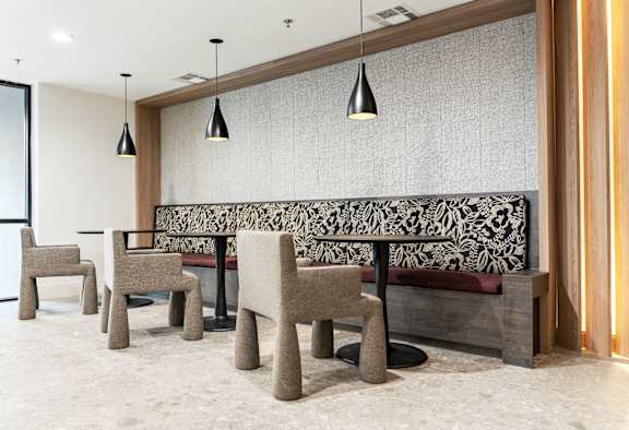 Row of chairs are lined up in front of a patterned bench at Vera Cortez Hill, San Diego