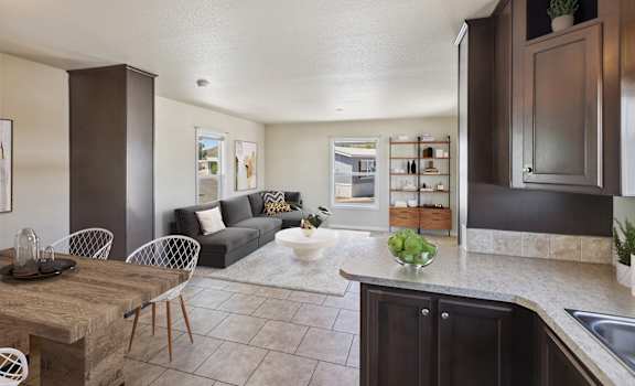 A kitchen with a table and chairs in the middle of the room.