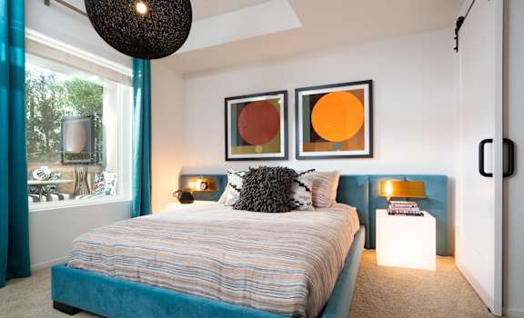 a bedroom with a blue bed and a large window at Vida North Park, San Diego, 92104