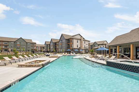 the resort style pool with lounge chairs at the resort at governors crossing at Notch66, Longmont, Colorado