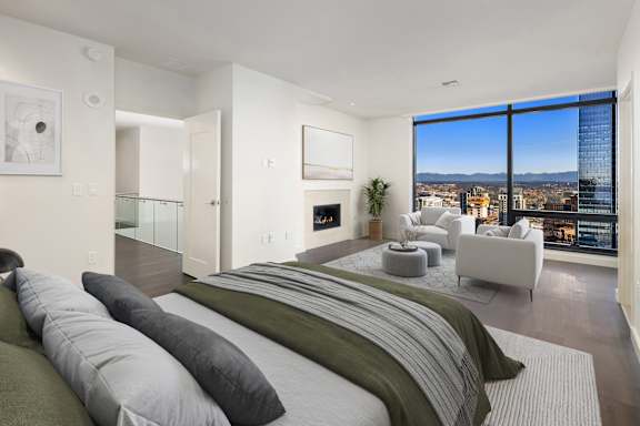 A penthouse bedroom at Two Lincoln Tower with a view of Bellevue.
