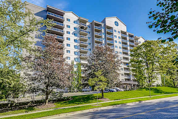 a large apartment building with trees in front of it