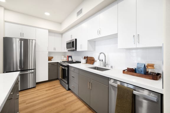 a modern kitchen with stainless steel appliances and white cabinets at Anacapa Canyon, Camarillo, 93012