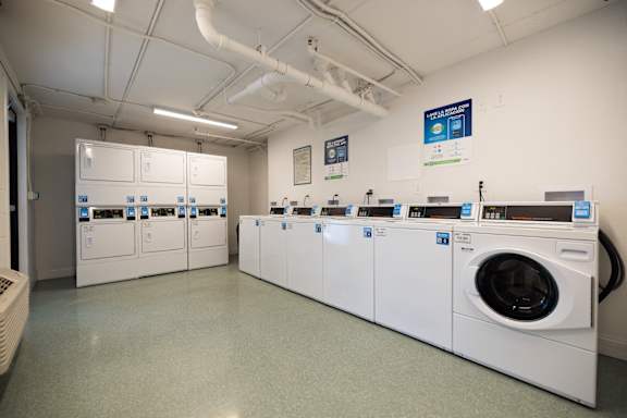 a row of washing machines and dryers in a laundry room at The Teale, Kissimmee, FL, 34746