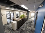 Thumbnail 11 of 14 - a view of an office area with a desk and a filing cabinet at 100 South Apartments, Buffalo, New York