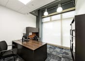 Thumbnail 10 of 14 - an office with a desk and a window at 100 South Apartments, Buffalo, New York 14202