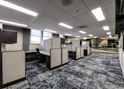 Thumbnail 7 of 14 - an empty office space with rows of cubicles and desks at 100 South Apartments, Buffalo, NY