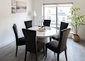 Thumbnail 5 of 5 - a dining room with a table and chairs and a window