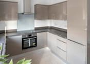 Thumbnail 4 of 5 - a modern kitchen with white cabinets and stainless steel appliances