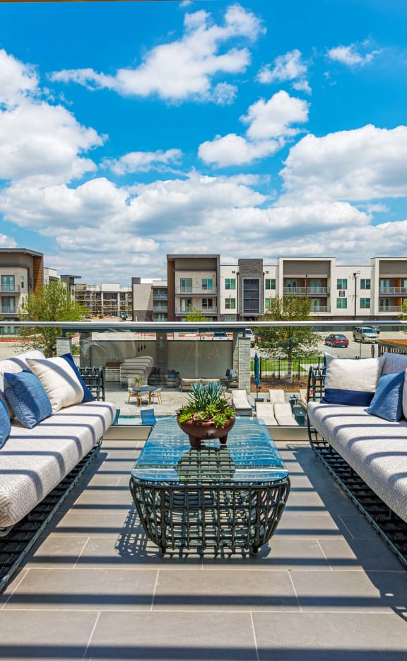 a rooftop patio with couches and a coffee table at Presidium Revelstoke, Texas