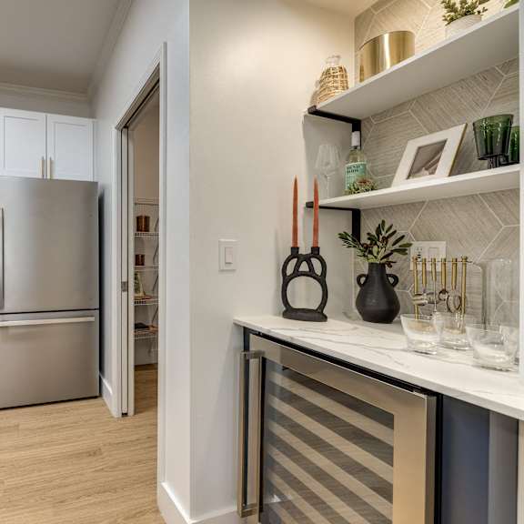 A kitchen with a refrigerator, oven, and microwave.