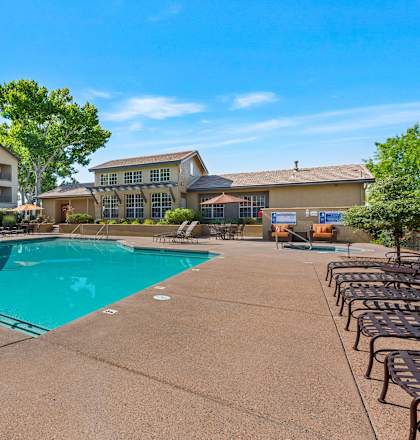 our apartments have a swimming pool with chairs and umbrellas