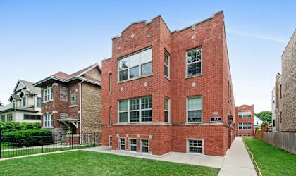 a red brick building with a sidewalk in front of it