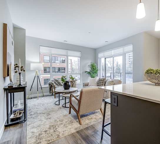 an open living room with a kitchen and a dining room  at 101 Base Line Road West, London, ON