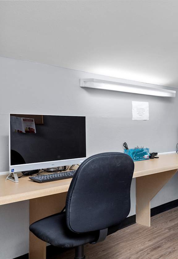 two computers and two chairs in an office
