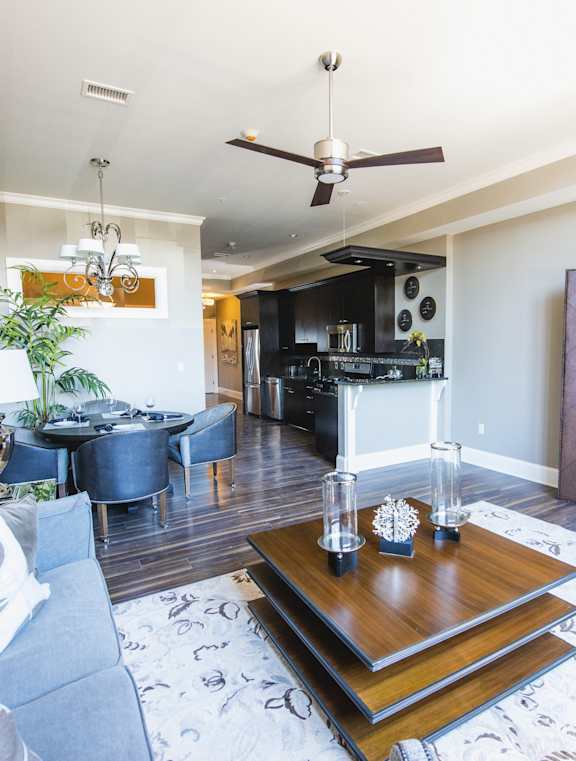 A living room with a grey couch and a wooden coffee table. at The Knights @ 506 Delaware Apartments, Buffalo, New York 14202