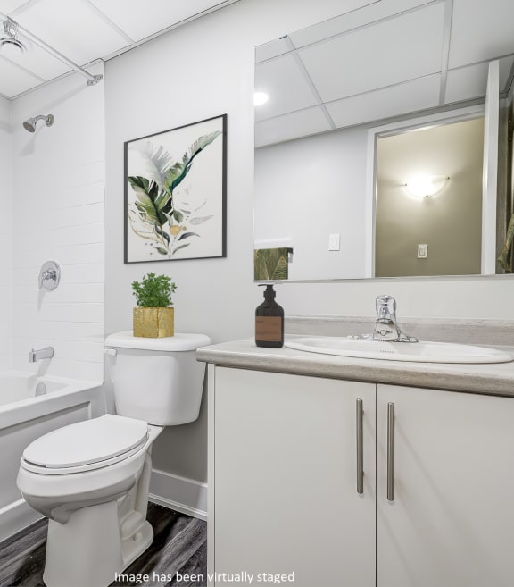 a kitchen with white cabinets and white appliances at Platts Crossing, London, ON