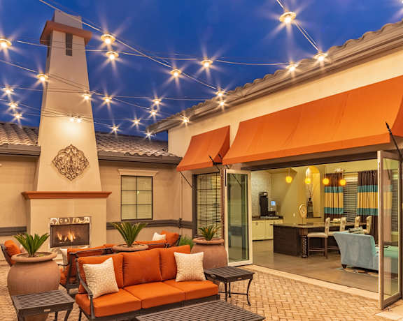 A patio area with a fireplace and seating area.