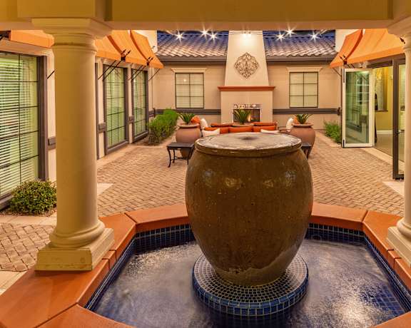 A large stone sphere sits in the middle of a pool.