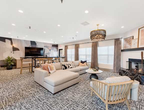 a living room with couches and chairs and a fireplace
