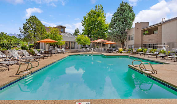 our apartments have a swimming pool with chairs and umbrellas