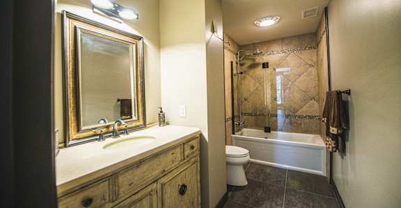 a bathroom with a sink and a shower and a toilet at The Knights @ 506 Delaware Apartments, NY 14202