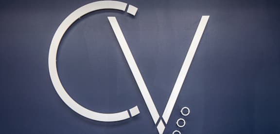 a sign for a vw logo on a wall