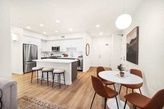 a living room with a kitchen and a table with chairs at Anacapa Canyon, Camarillo, 93012