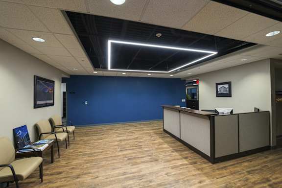 a lobby with a blue wall and a reception desk at 100 South Apartments, Buffalo, New York 14202